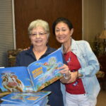 CWJF members pose with book used for BookSmart