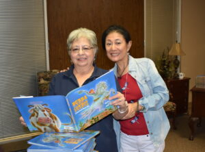 CWJF members pose with book used for BookSmart